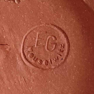 Ceramic mark by Erhard Goschala: EG Meuselwitz in a circle.