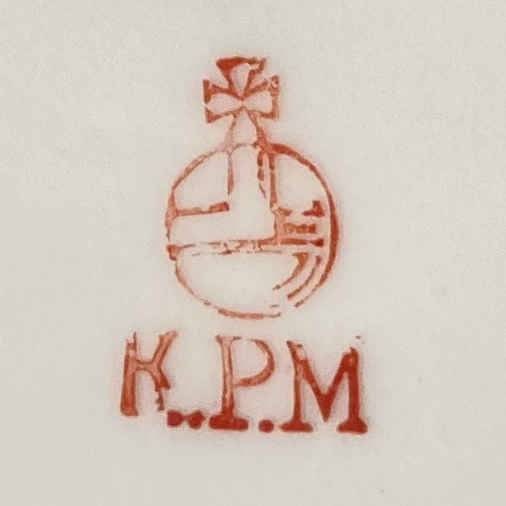 Porcelain mark by KPM: K.P.M. with red orb