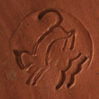 One of several ceramic marks of the Studio Hohlt: cat aligned to the left with two waves underneath (double and wavy underlined).